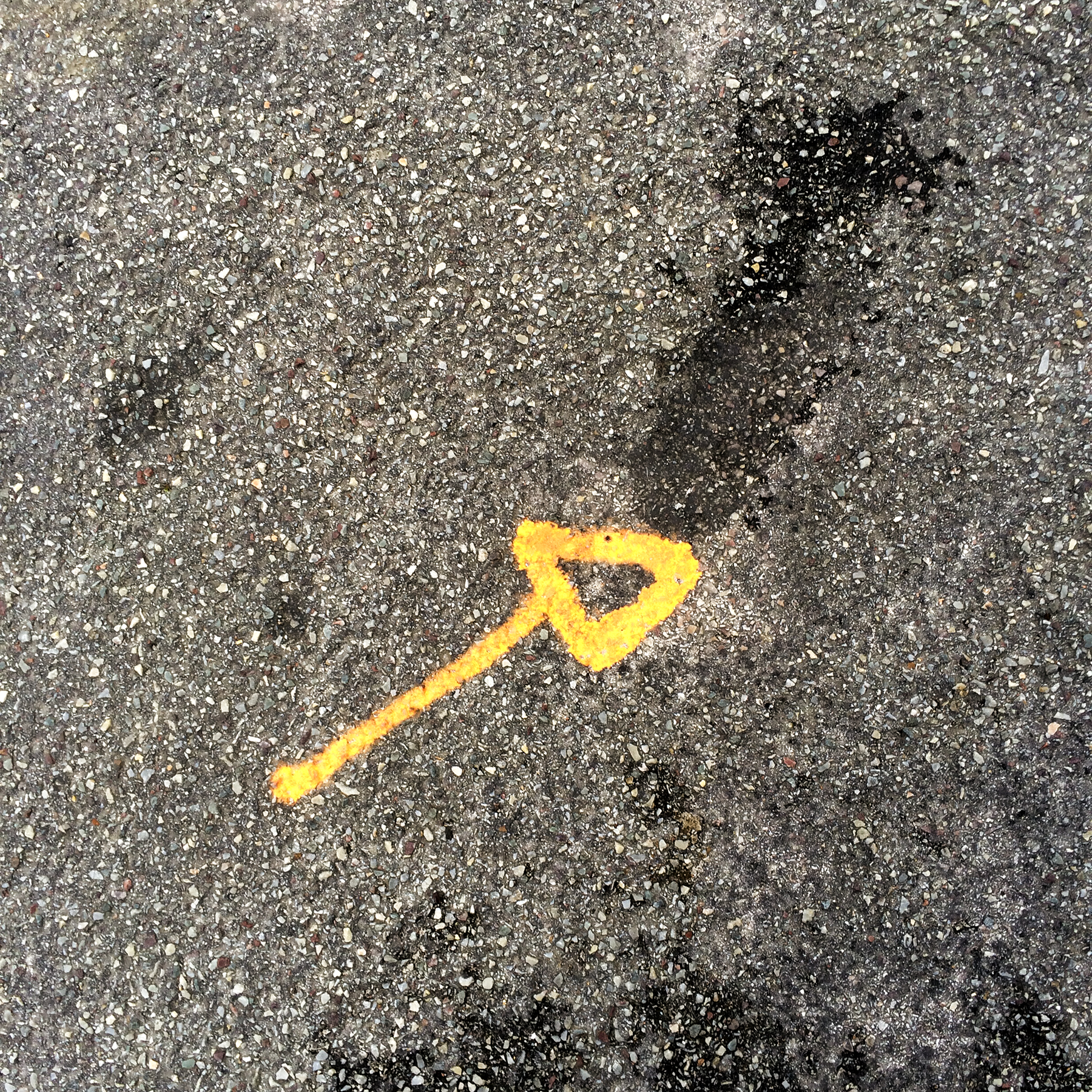 5th of 6 placeholder images: yellow arrow spraypainted on pavement